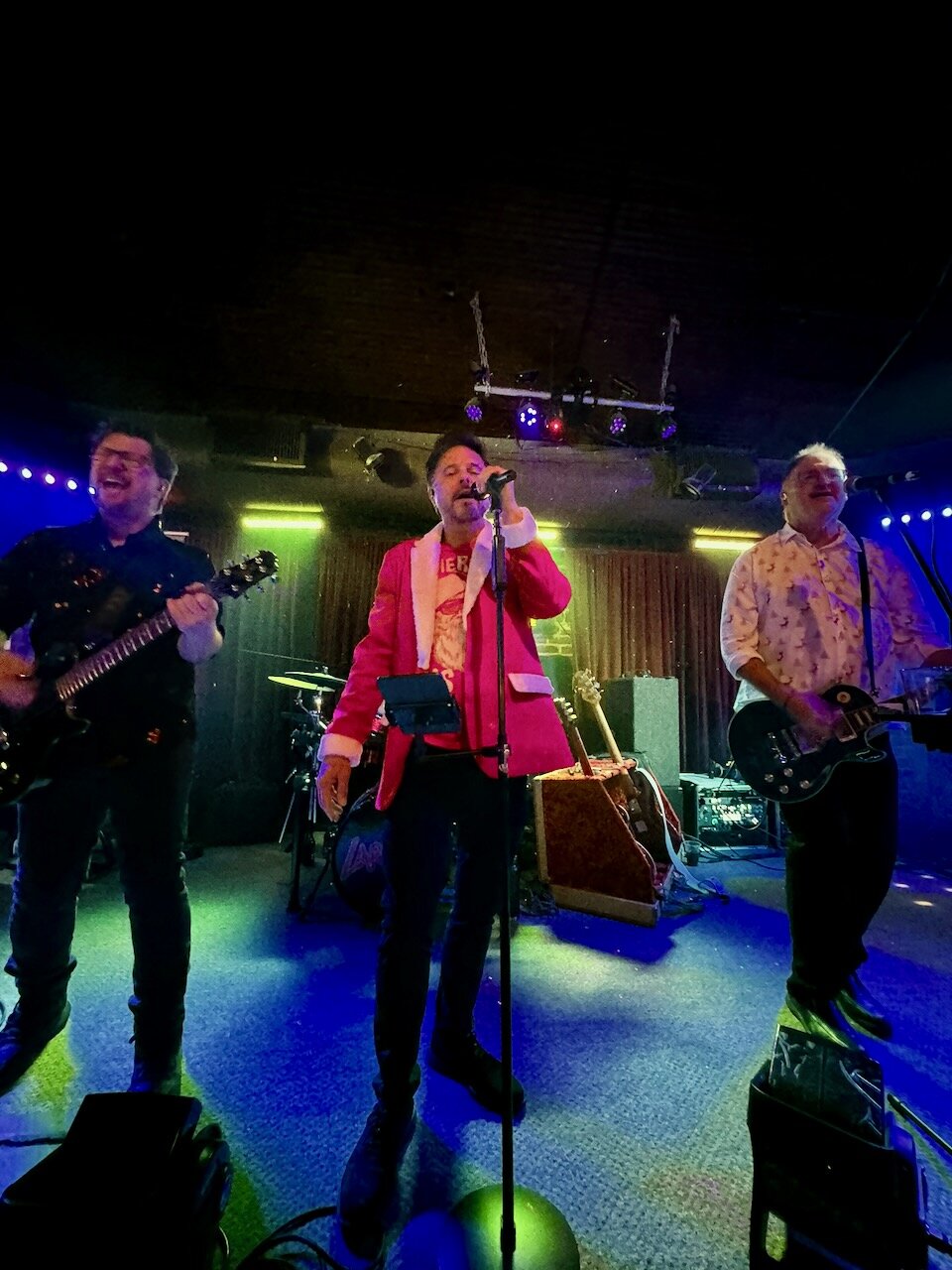 Larceny vocalist Erik Wilson in red jacket performing with Dan and Kevin at Sky Music Lounge