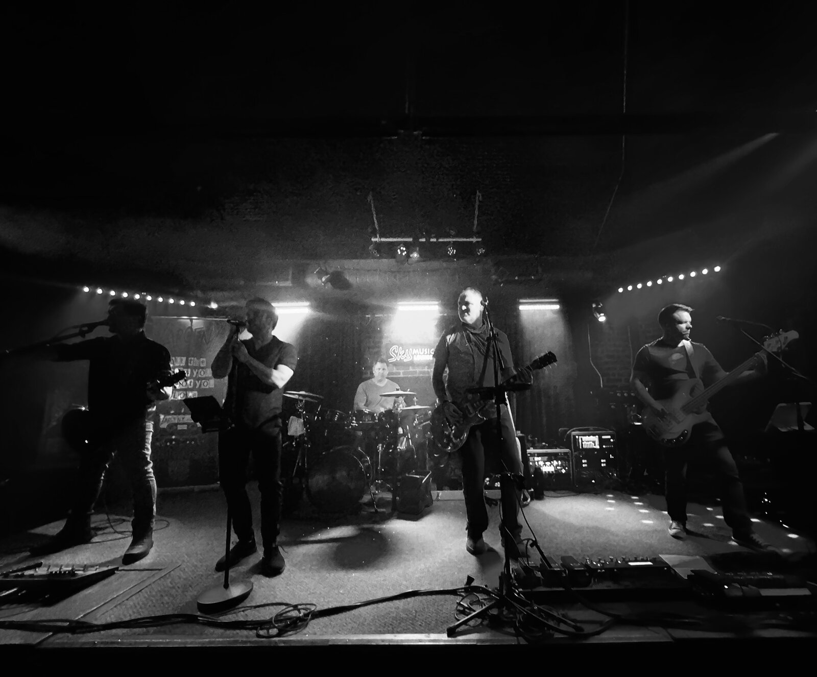 Larceny full band black and white silhouette shot at Sky Music Lounge