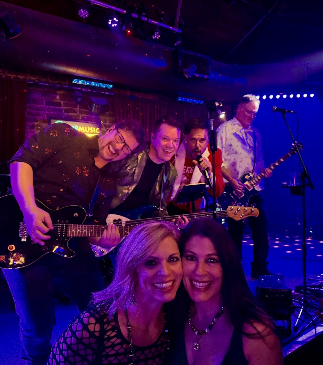 Larceny band members and fans posing together during a show at Sky Music Lounge