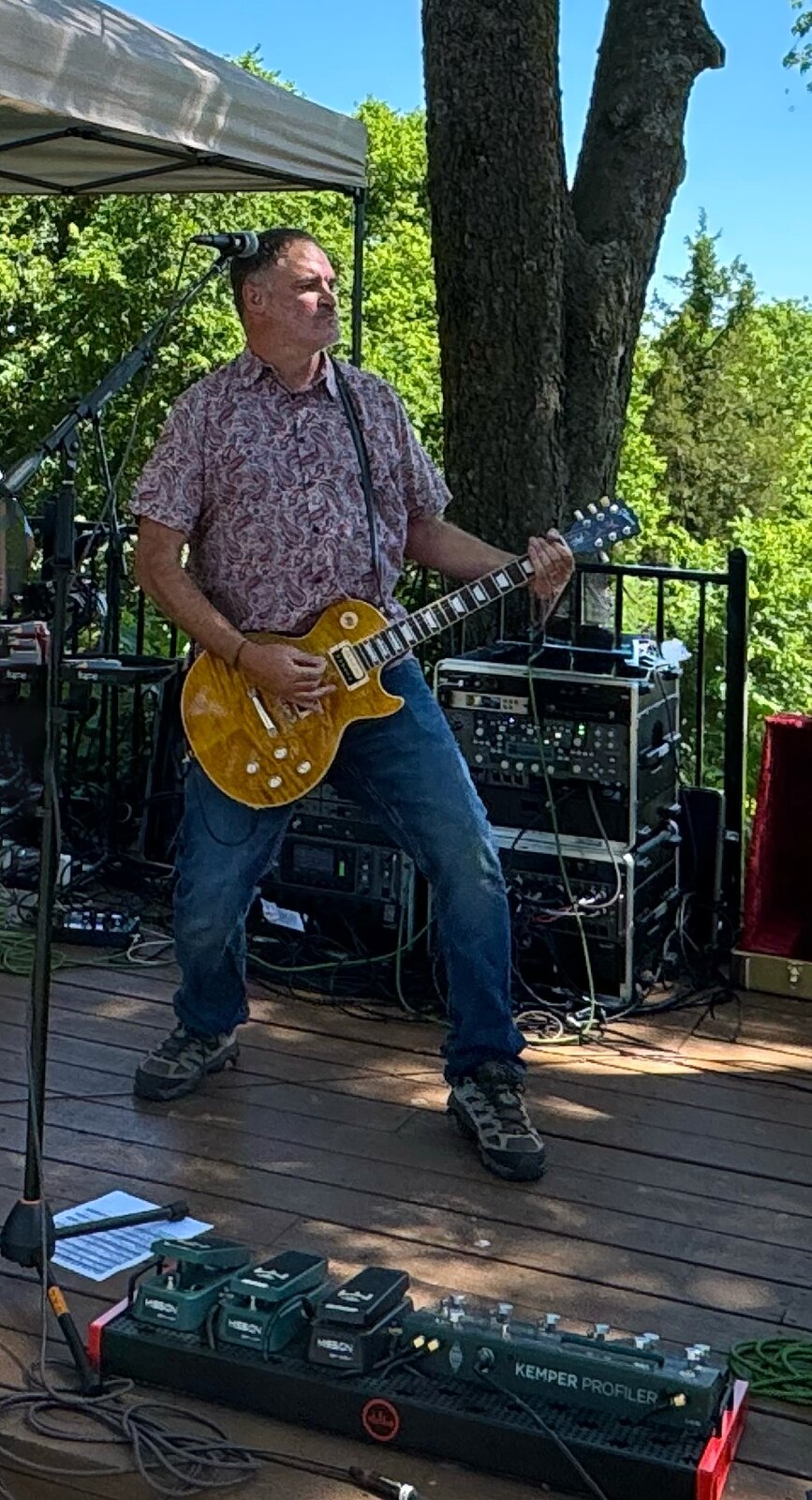 Kevin playing lead guitar at outdoor show